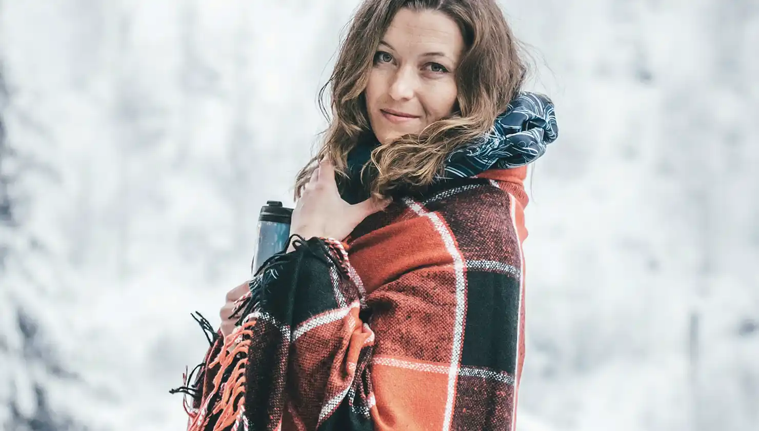 Woman bundled up cozy in winter, potential plastic surgery patient