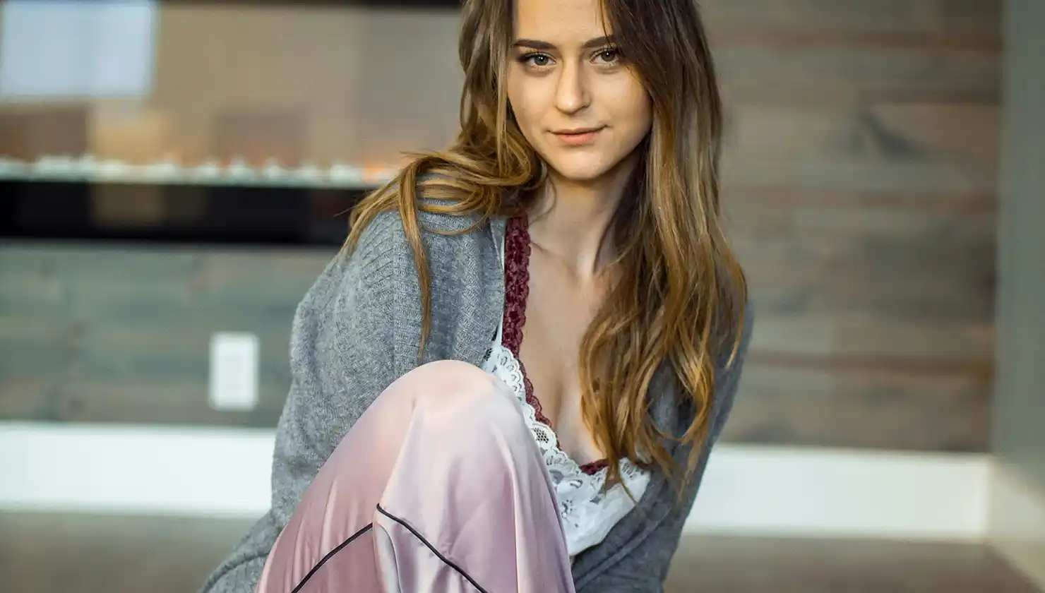 Young woman in sexy loungewear in a cozy setting posing with confidence