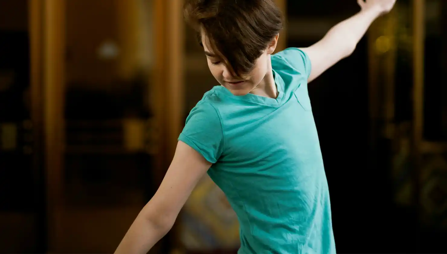 Possible top surgery patient post-surgery. Showing a person feeling confident in their body.